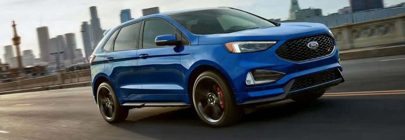 2019 ford edge driving down the road through the city